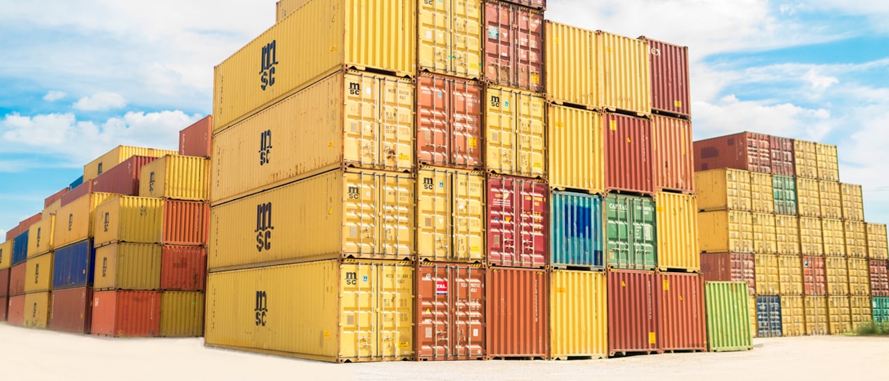 Rows of intermodal shipping containers stacked at a depot