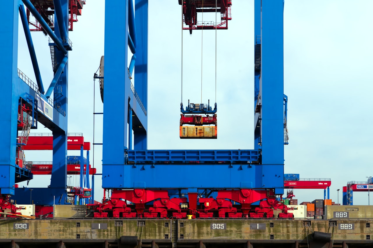 A gantry crane lifting a shipping container