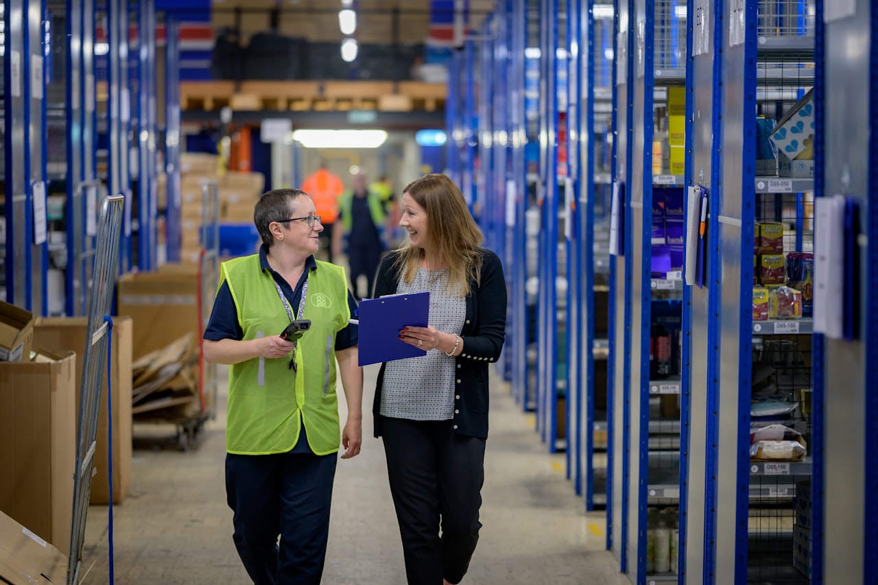 Two warehouse colleagues reviewing a consignment together